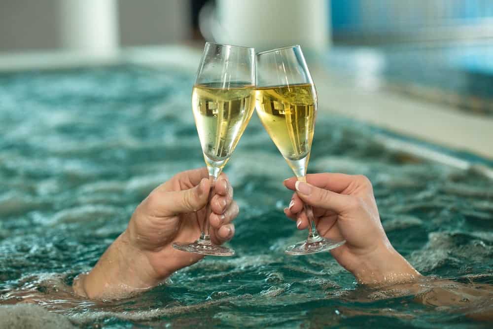 couple champaign toast in a swimming pool