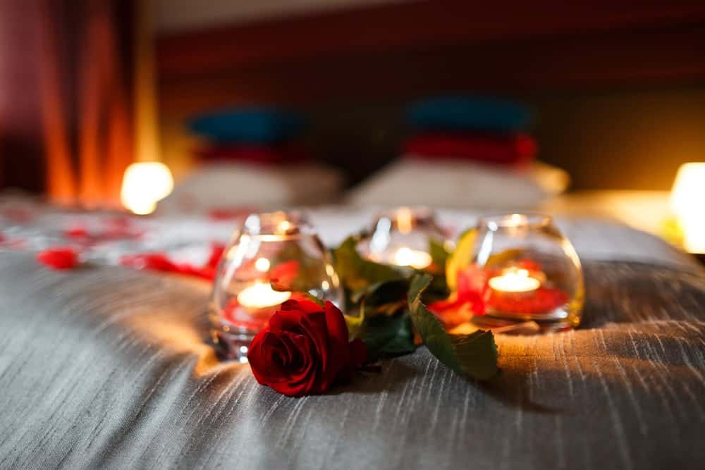 rose-and-candles-on-hotel-bed.jpg