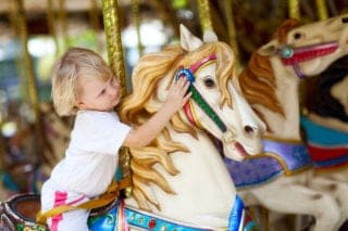 child on carousel dollywood
